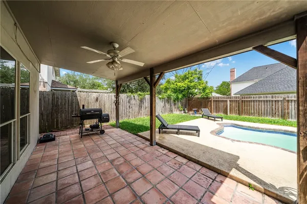 a view of a patio with a table and chairs