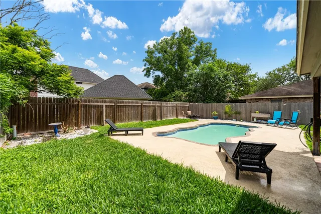 a view of a chair and table in the backyard