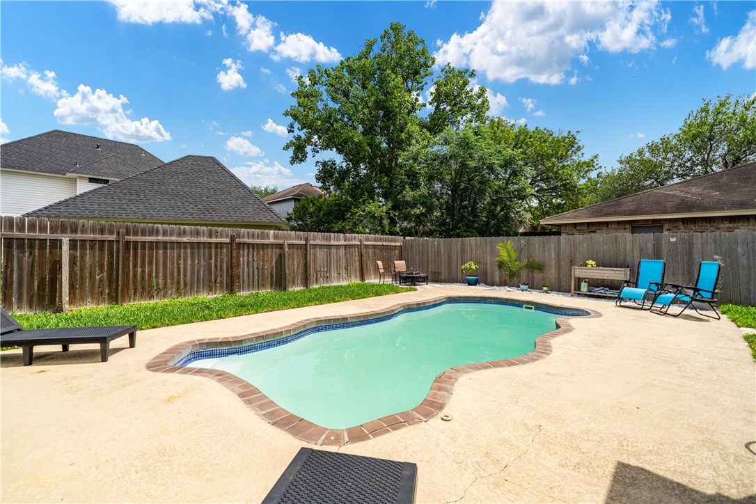 7630 Cedar Brook Drive Corpus Christi, TX 78413 - Photo 28 of 32 a view of swimming pool with seating area and green space