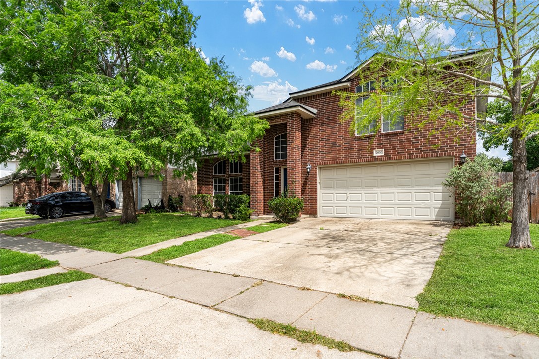 7630 Cedar Brook Drive Corpus Christi, TX 78413 - Photo 5 of 32 a front view of a house with garden