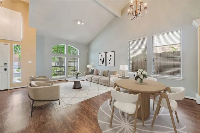 a living room with fireplace furniture and a large window