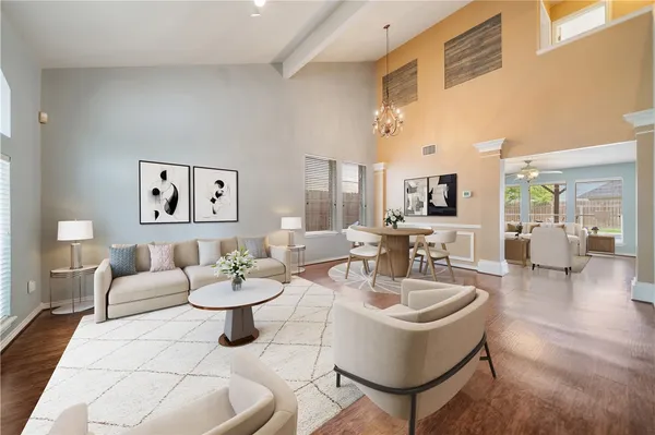 a living room with fireplace furniture and a large window