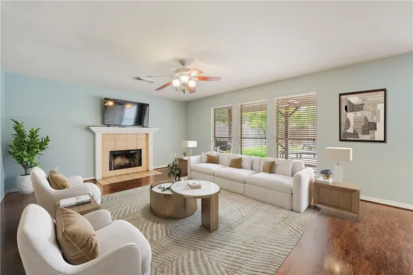 a living room with furniture two window and a fireplace