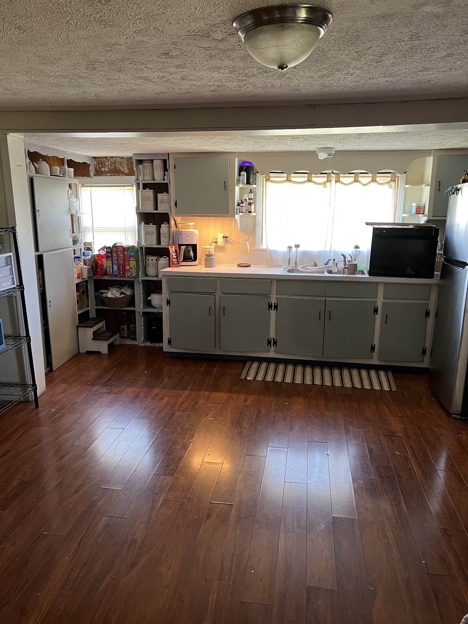 400 Hurricane Loop Tennessee Ridge, TN 37178 - Photo 3 of 7 a kitchen with cabinets and wooden floor