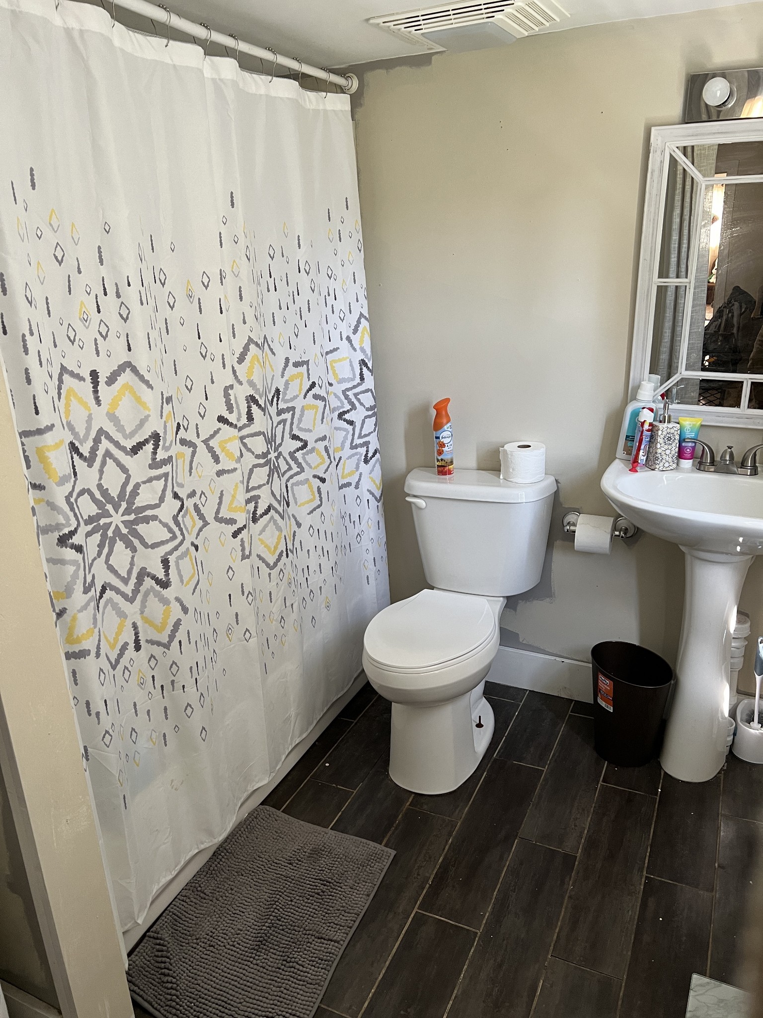 400 Hurricane Loop Tennessee Ridge, TN 37178 - Photo 5 of 7 a white toilet sitting next to a white sink and a shower curtain