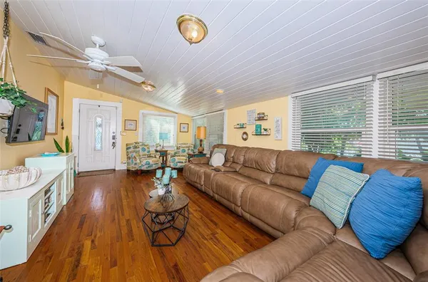 a living room with furniture and wooden floor