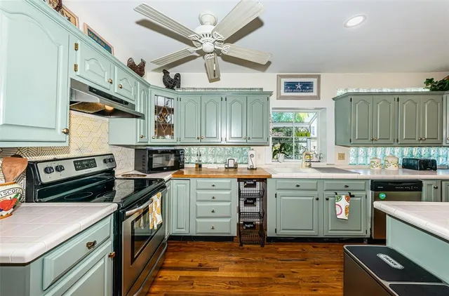 a kitchen with stainless steel appliances granite countertop a stove and cabinets