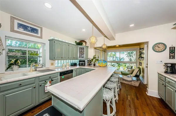 a kitchen with lots of counter top space and wooden floor