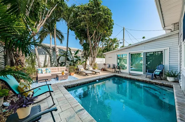 a view of patio with swimming pool table and chairs