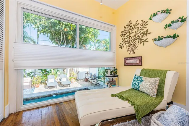 a living room with furniture and a floor to ceiling window