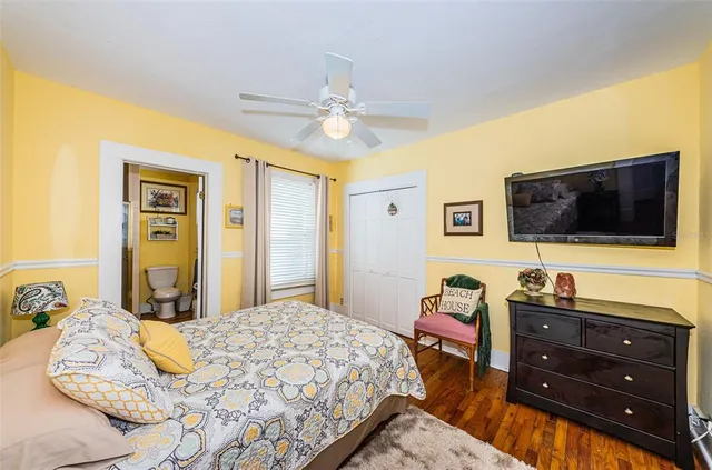 a bedroom with a bed and a flat screen tv