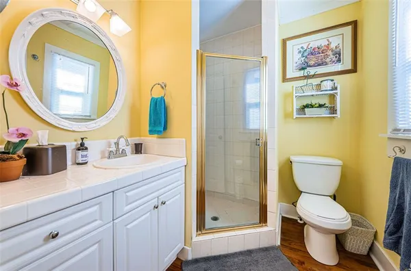 a bathroom with a toilet a sink and a mirror