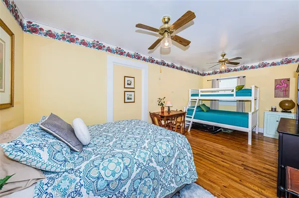a bedroom with a bed and a chandelier