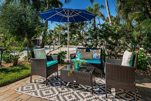 a view of a chairs and table in backyard