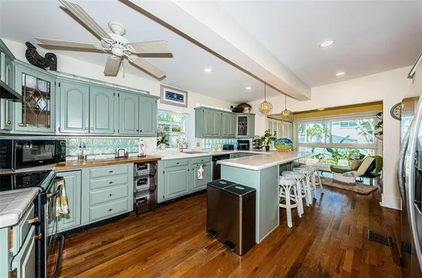 a kitchen with sink cabinets and wooden floor