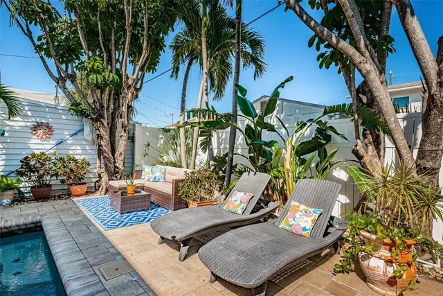 a view of a backyard with plants and a patio