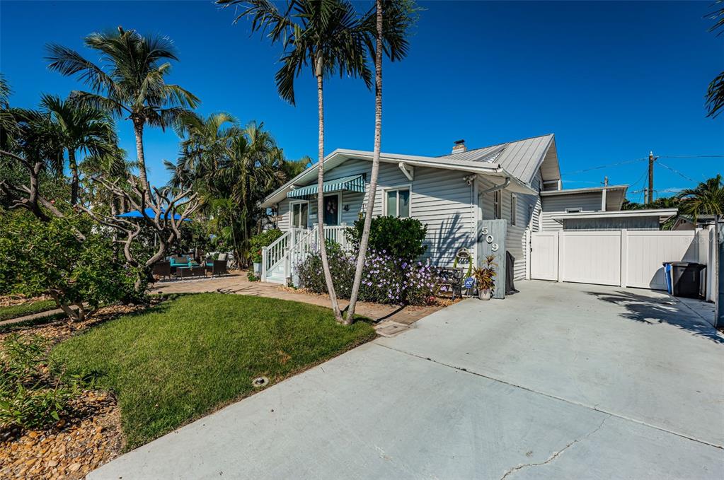 509 70th Avenue St. Pete Beach, FL 33706 - Photo 6 of 50 a front view of a house with a garden
