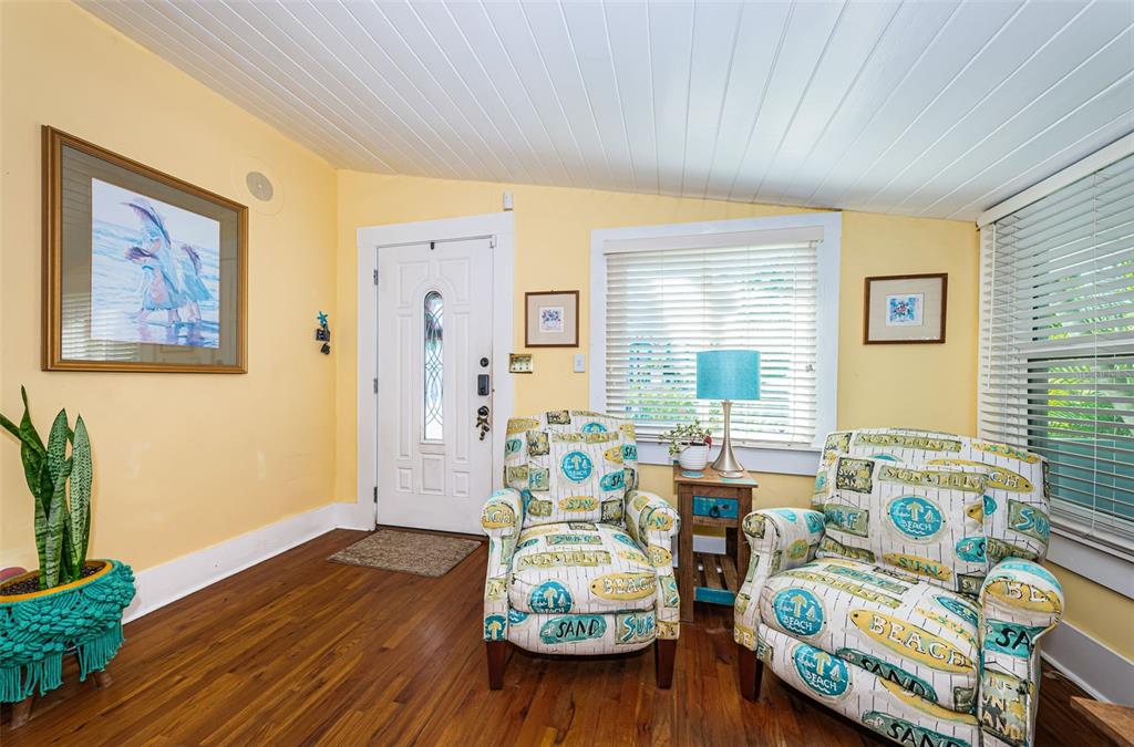 509 70th Avenue St. Pete Beach, FL 33706 - Photo 9 of 50 a view of a dining room with furniture a window and wooden floor