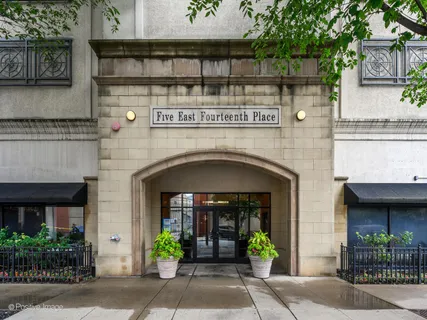 a front view of a building with potted plants