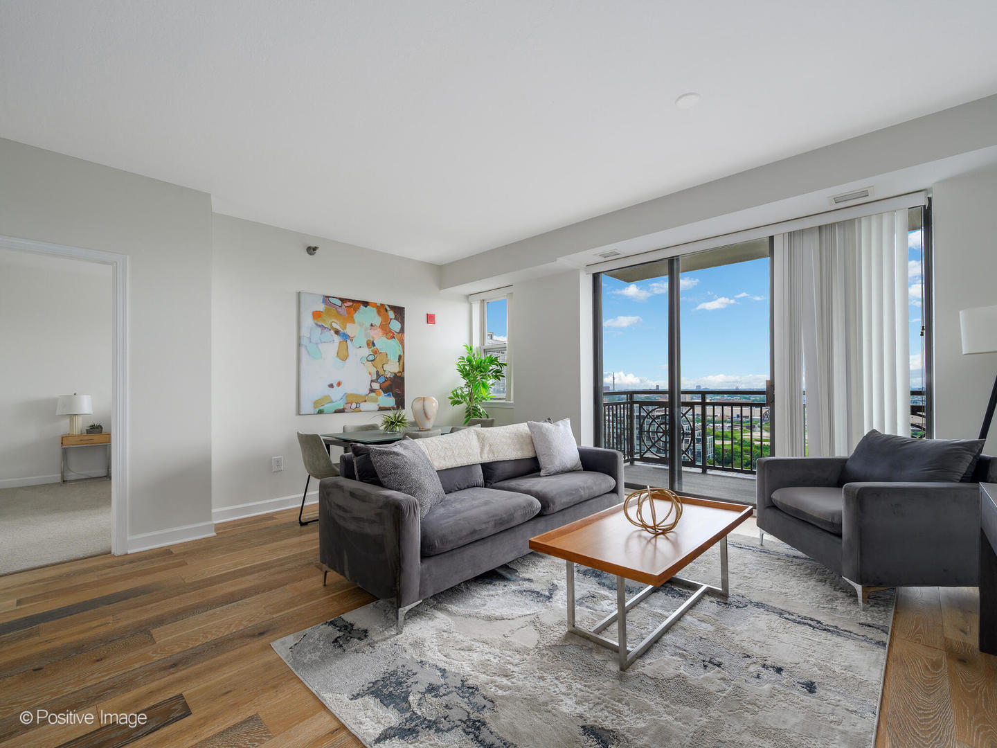 5 East 14th Place, Unit 1506 Chicago, IL 60605 - Photo 5 of 23 a living room with furniture and a large window