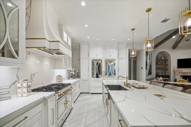 a large kitchen with stainless steel appliances kitchen island granite countertop a sink and cabinets