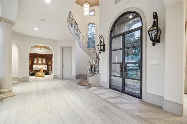 a view of a livingroom with furniture entryway and wooden floor