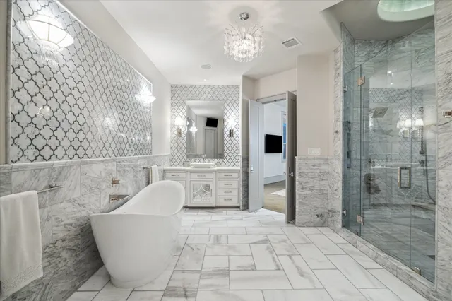 a bathroom with a bathtub shower sink and mirror