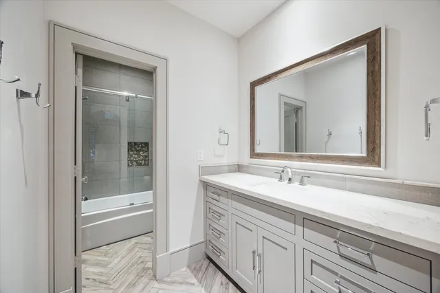 a bathroom with a sink and a mirror