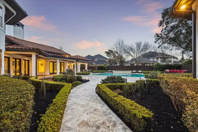 a front view of a house with swimming pool having outdoor seating