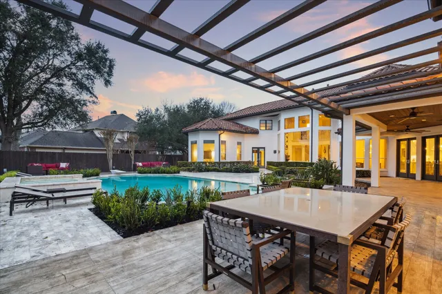 a view of a patio with table and chairs potted plants with wooden floor and fence