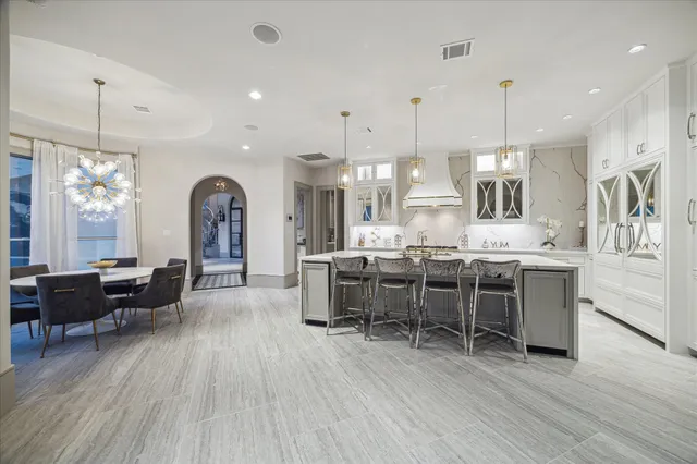 a large kitchen with a table and chairs in it