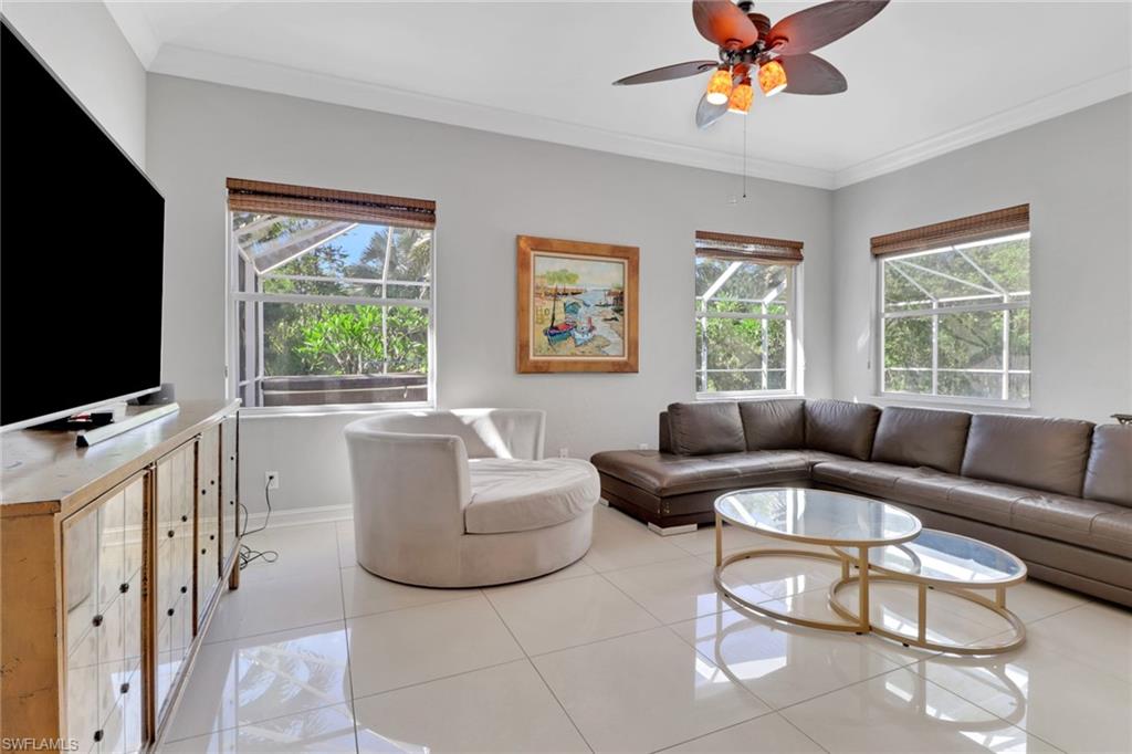 4380 7th Avenue Southwest Naples, FL 34119 - Photo 12 of 39 a living room with furniture a flat screen tv and a large window