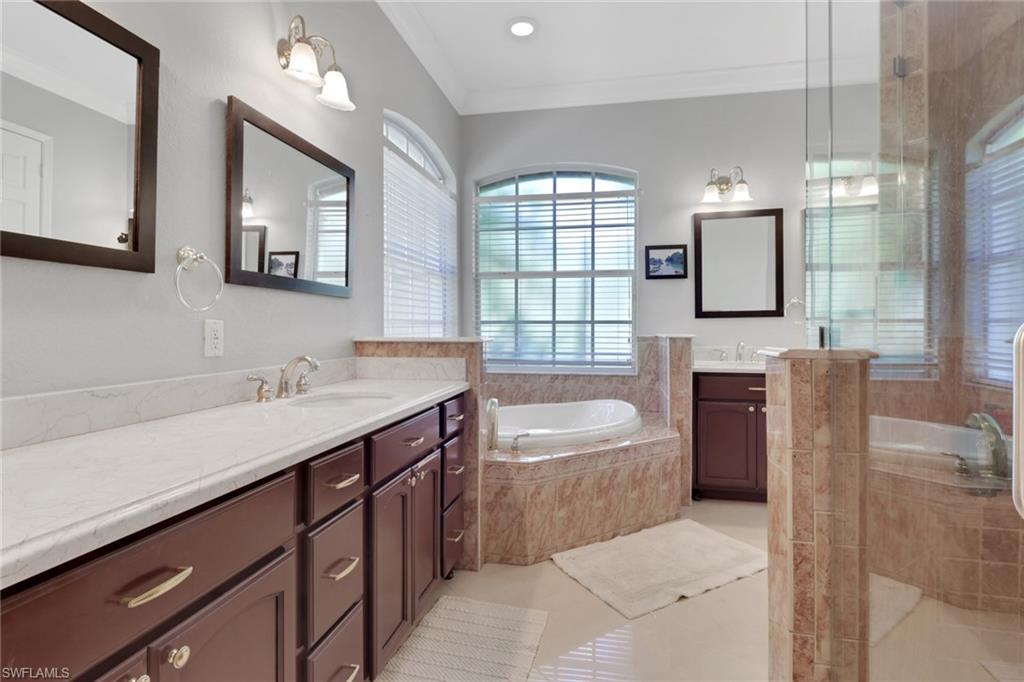 4380 7th Avenue Southwest Naples, FL 34119 - Photo 21 of 39 a bathroom with a tub sink and mirror