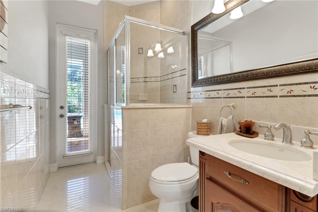 4380 7th Avenue Southwest Naples, FL 34119 - Photo 23 of 39 a bathroom with a sink a toilet and shower