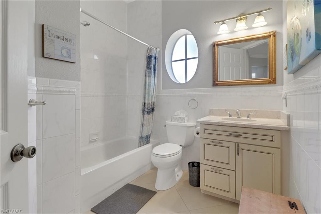 4380 7th Avenue Southwest Naples, FL 34119 - Photo 24 of 39 a bathroom with a toilet sink and mirror