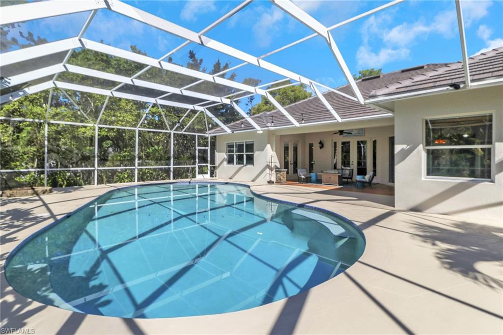 4380 7th Avenue Southwest Naples, FL 34119 - Photo 27 of 39 a view of a white building with swimming pool in front of it