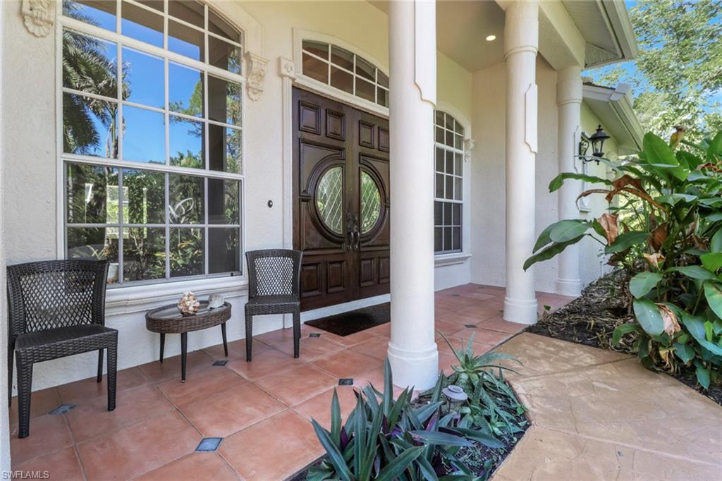 4380 7th Avenue Southwest Naples, FL 34119 - Photo 4 of 39 a view of a building with a potted plant and a bench