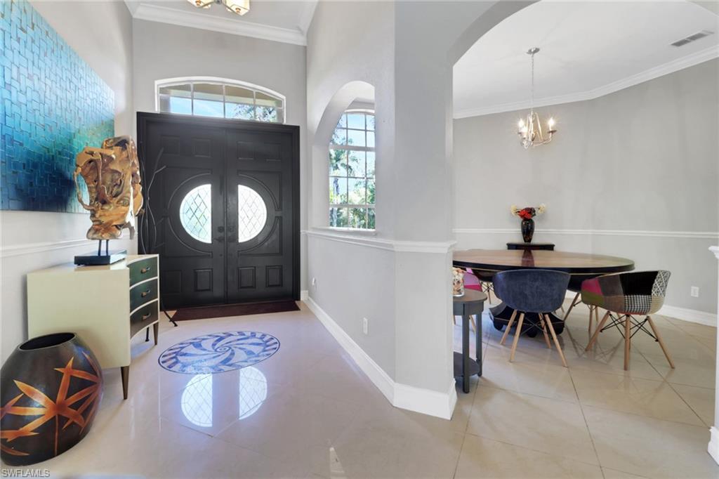 4380 7th Avenue Southwest Naples, FL 34119 - Photo 5 of 39 a view of a livingroom with furniture and a mirror