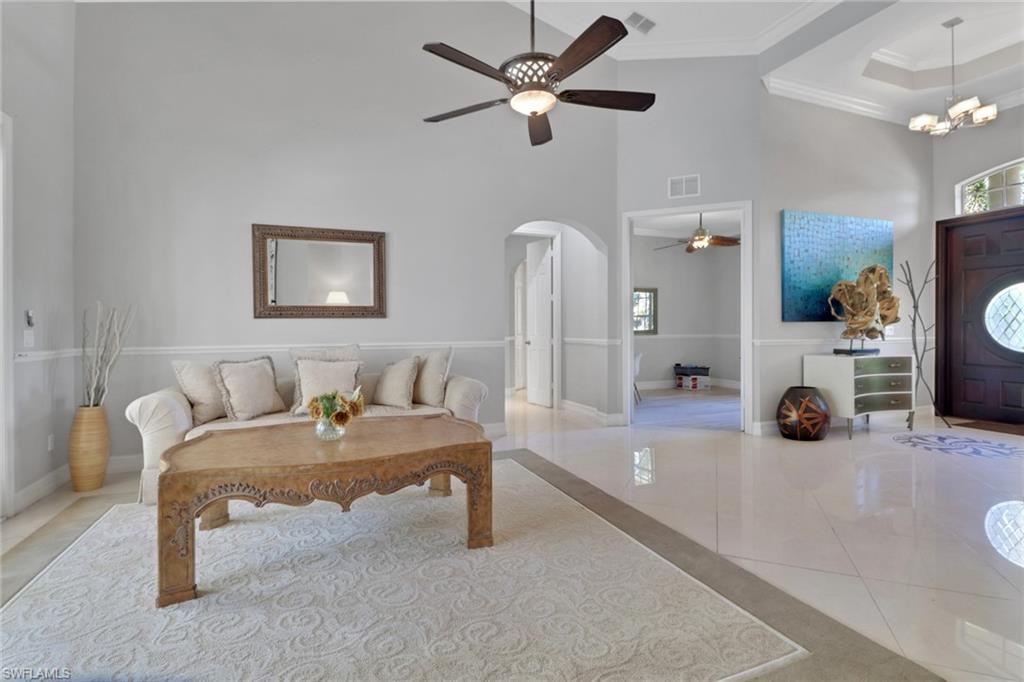 4380 7th Avenue Southwest Naples, FL 34119 - Photo 6 of 39 a bedroom with a bed and a chair