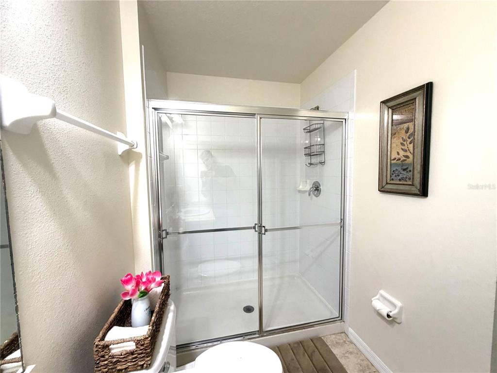 4573 Ada Lane Kissimmee, FL 34746 - Photo 19 of 37 a bathroom with a shower and a sink