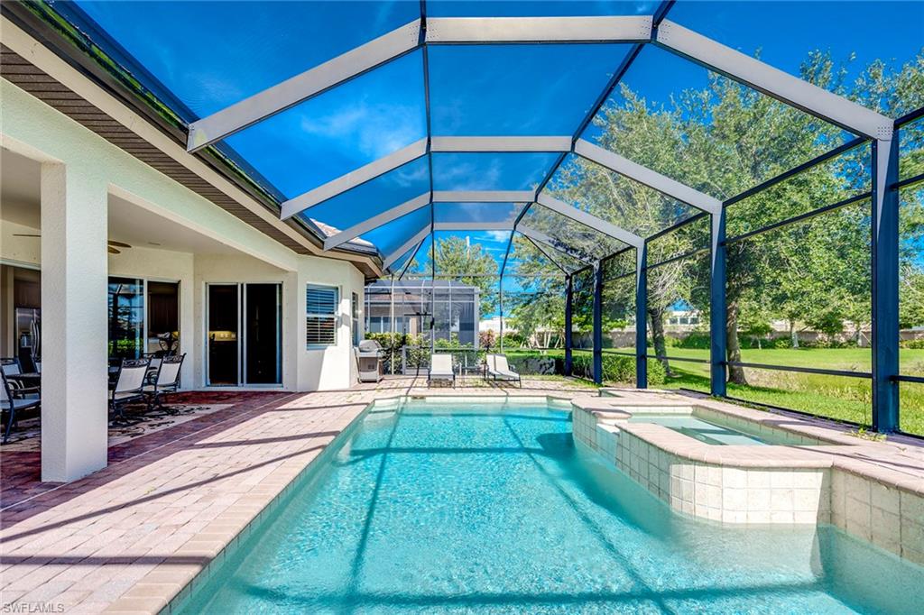 6065 Divot Court Naples, FL 34113 - Photo 14 of 18 a house view with a sitting space and garden view