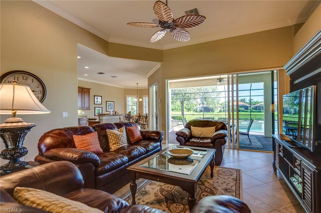6065 Divot Court Naples, FL 34113 - Photo 2 of 18 a living room with furniture and a flat screen tv