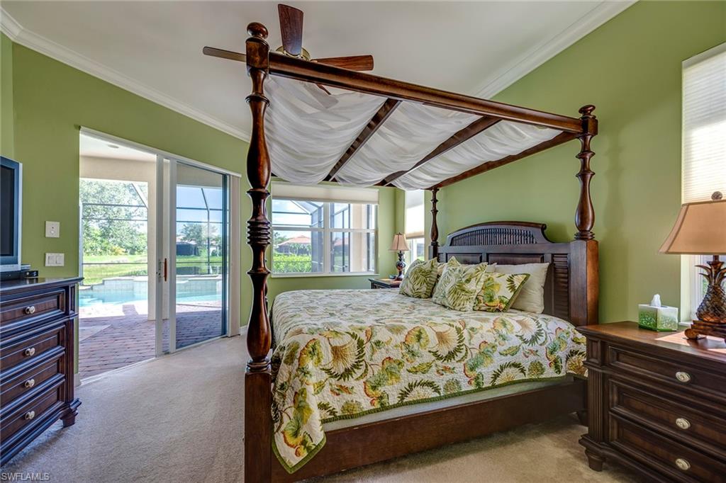 6065 Divot Court Naples, FL 34113 - Photo 6 of 18 a bedroom with a bed and large windows
