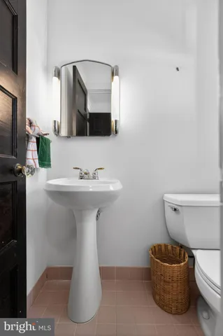 a bathroom with a sink toilet and mirror