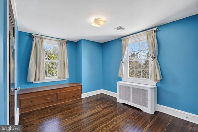 a view of room with window and wooden floor