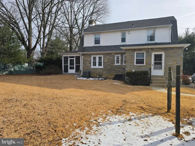 a front view of house with yard and trees around