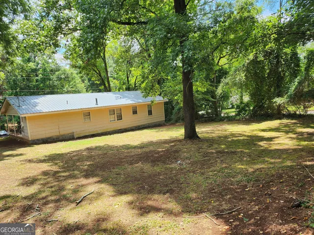 a view of a large yard with large trees