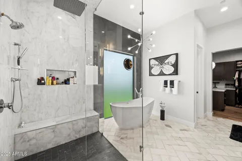 a spacious bathroom with a tub shower and mirror