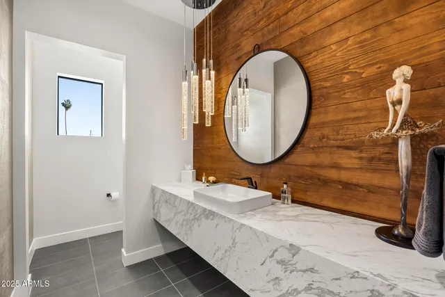 a bathroom with a sink mirror and vanity