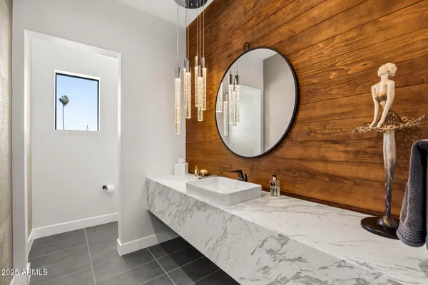 a bathroom with a sink mirror and vanity